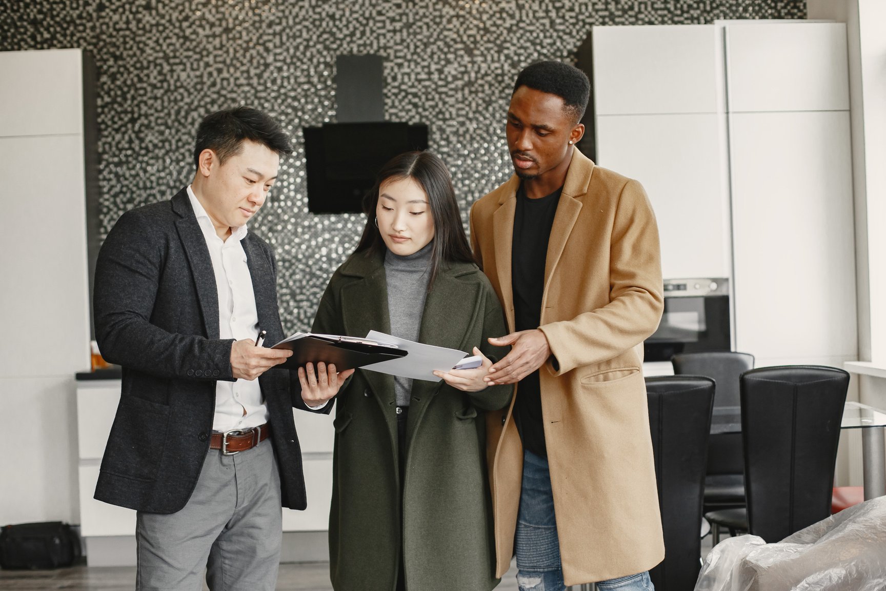 Couple Discussing with Realtor About the Contract of Apartment